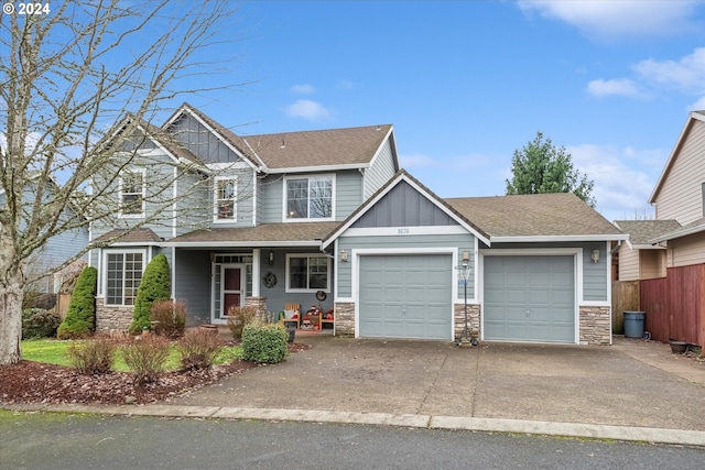 craftsman house with covered porch and a garage