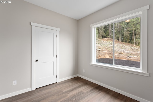 130 E H St, Vernonia, OR 97064 - spare room featuring baseboards, wood finished floors, and plenty of natural light