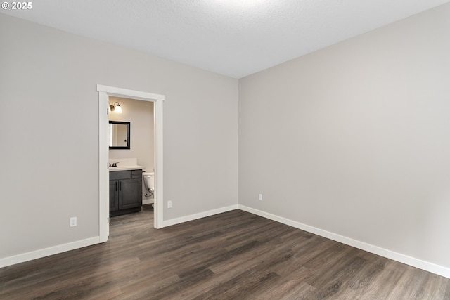 130 E H St, Vernonia, OR 97064 - unfurnished bedroom featuring dark wood-style floors and baseboards