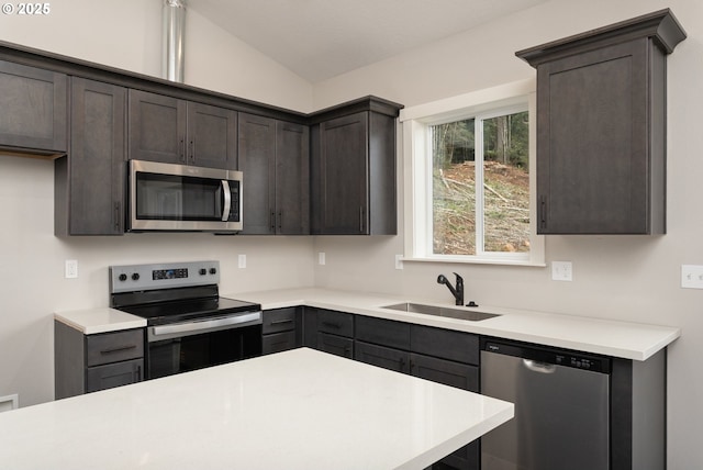 130 E H St, Vernonia, OR 97064 - kitchen featuring stainless steel appliances, a sink, dark brown cabinets, light countertops, and lofted ceiling