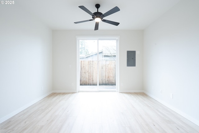 unfurnished room with ceiling fan, electric panel, and light hardwood / wood-style flooring