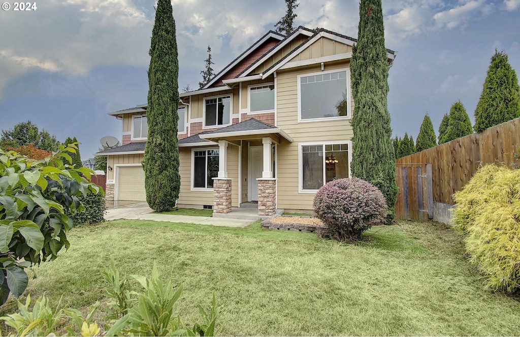 view of front of house with a garage and a front yard