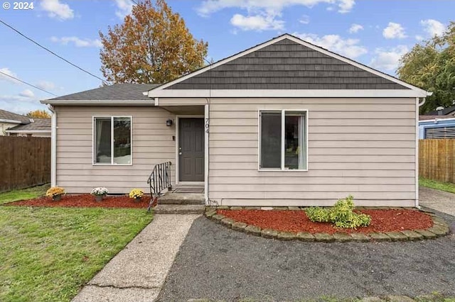 bungalow-style home featuring a front lawn