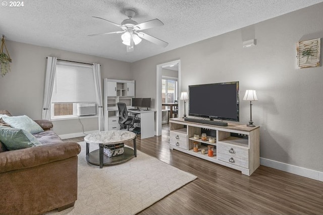 living room featuring dark hardwood / wood-style flooring, a textured ceiling, and ceiling fan