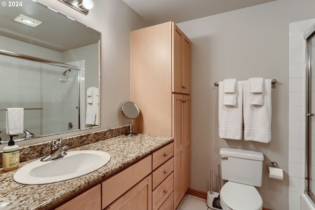 bathroom with vanity, an enclosed shower, and toilet