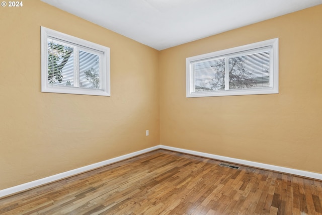 unfurnished room with hardwood / wood-style floors