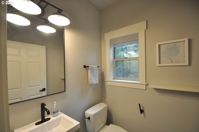 bathroom featuring toilet and sink