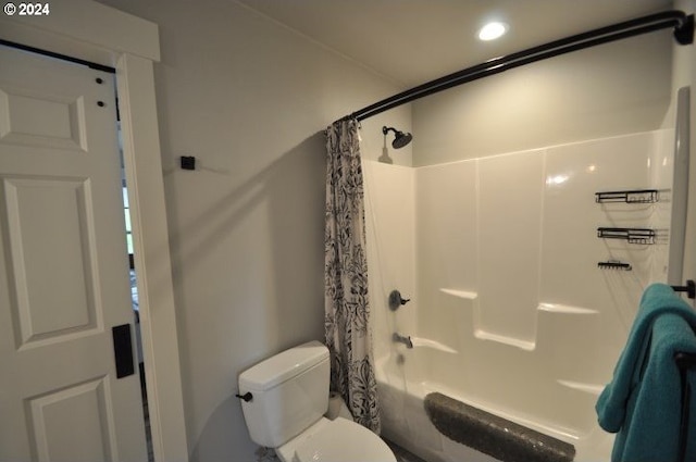 bathroom with shower / bath combo and toilet