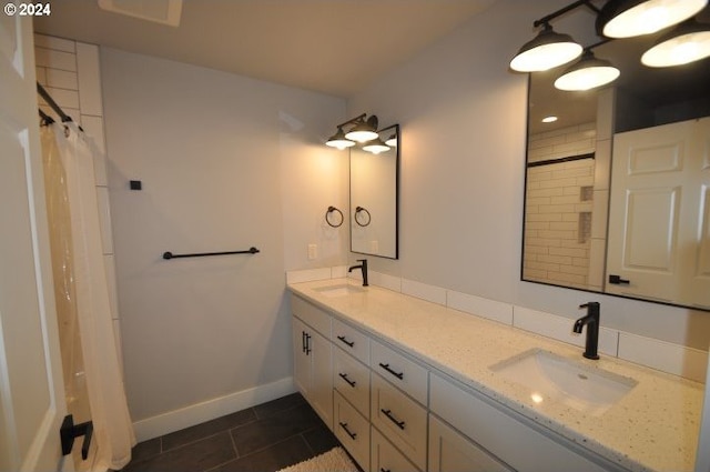 bathroom with tile patterned floors, vanity, and curtained shower