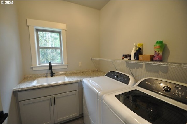 laundry area with cabinets, independent washer and dryer, and sink