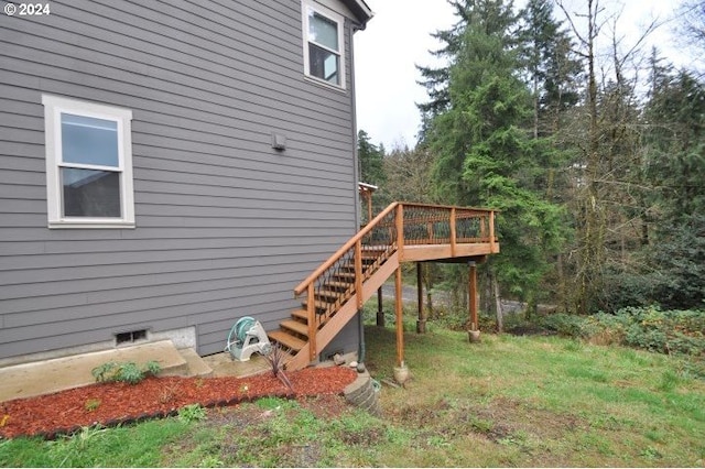 view of home's exterior featuring a wooden deck and a yard