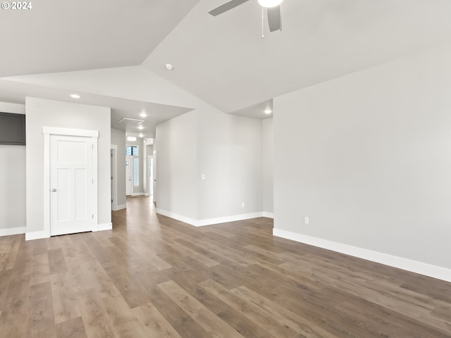 unfurnished living room with ceiling fan, hardwood / wood-style flooring, and lofted ceiling