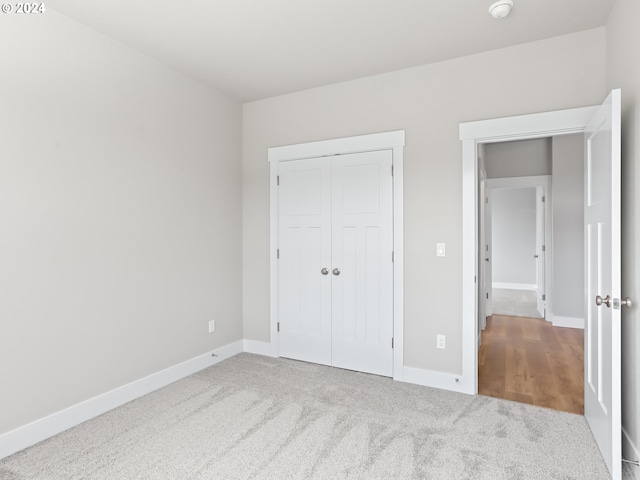 unfurnished bedroom with a closet and carpet flooring