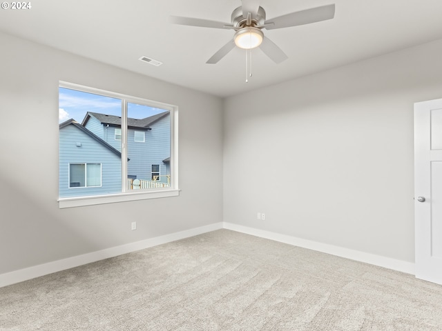 empty room with ceiling fan and carpet floors