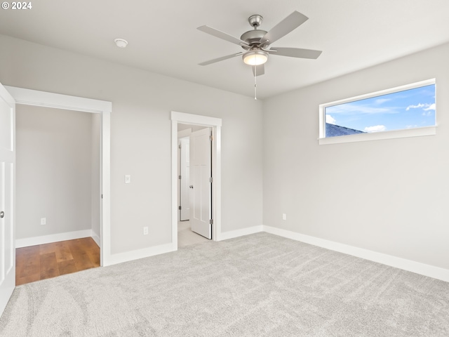 unfurnished bedroom with light carpet and ceiling fan