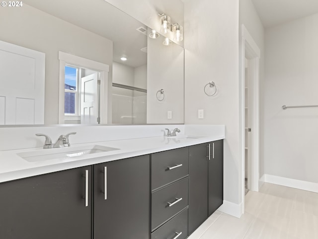 bathroom with tile patterned flooring, walk in shower, and vanity