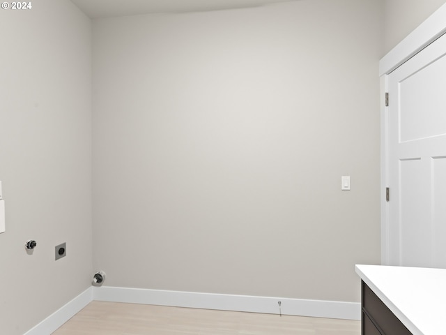 laundry area with light hardwood / wood-style floors and electric dryer hookup