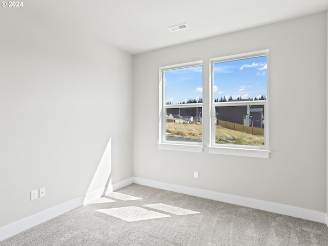 empty room featuring light carpet