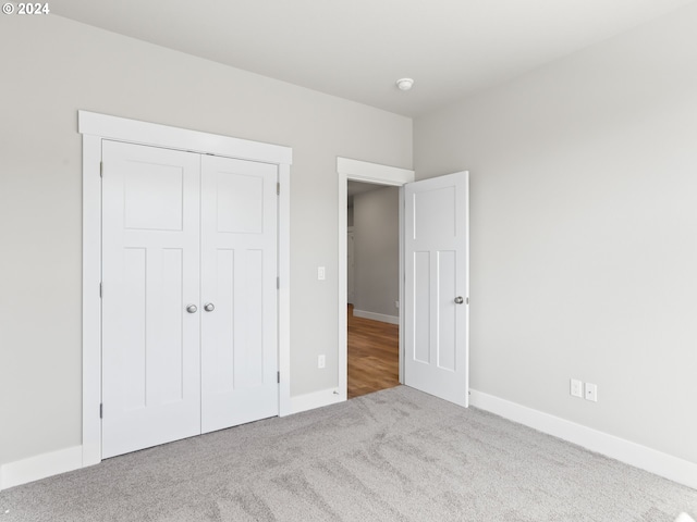 unfurnished bedroom featuring a closet and carpet