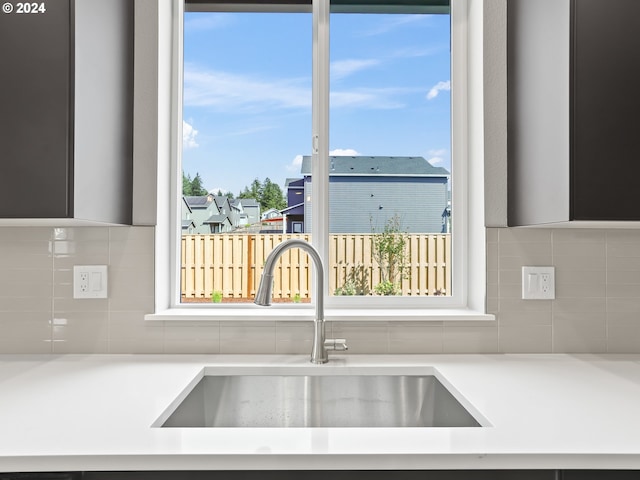 kitchen featuring tasteful backsplash and sink