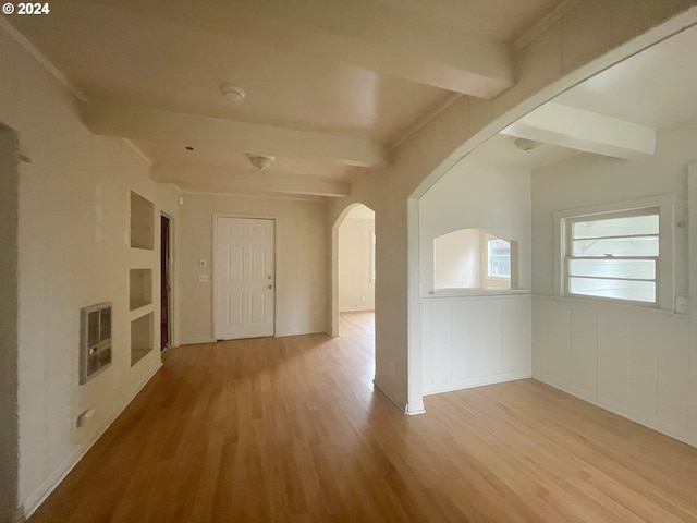 corridor with beam ceiling, light hardwood / wood-style flooring, and ornamental molding