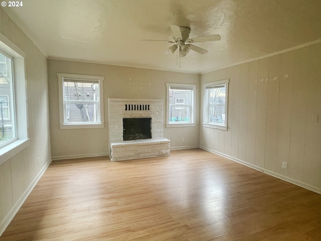 unfurnished living room featuring light hardwood / wood-style flooring, a wealth of natural light, and ceiling fan