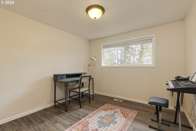 office featuring a textured ceiling and dark wood-type flooring