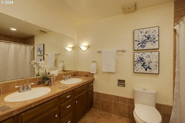 bathroom featuring tile patterned floors, vanity, and toilet