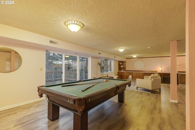 recreation room featuring hardwood / wood-style floors, a textured ceiling, and billiards