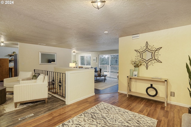 living room with hardwood / wood-style floors and a textured ceiling