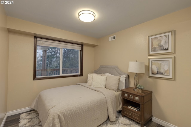 bedroom with hardwood / wood-style floors