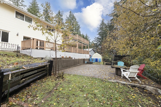 view of yard featuring a patio and a wooden deck