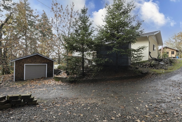 view of home's exterior featuring an outbuilding and a garage