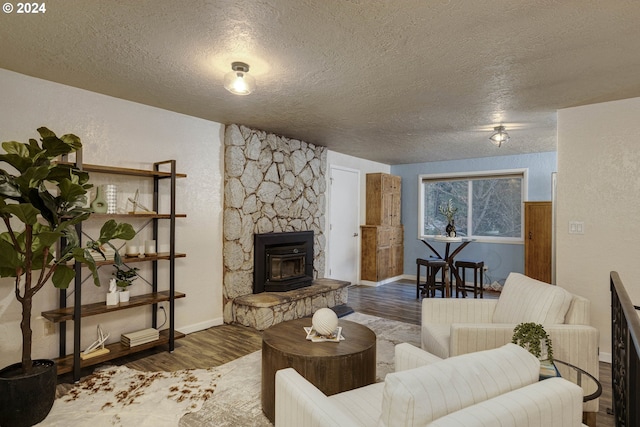 living room with wood-type flooring and a textured ceiling