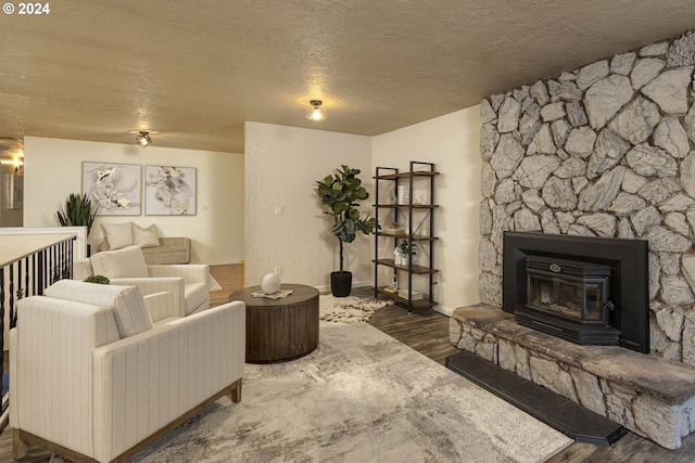 living room featuring dark wood-type flooring and a textured ceiling