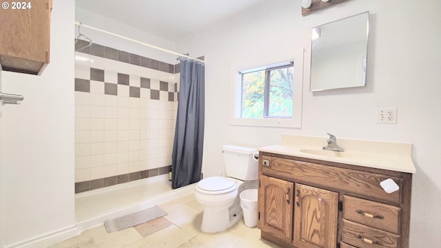 bathroom with a shower stall, toilet, vanity, and tile patterned flooring