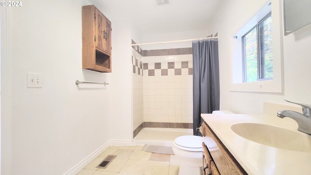 bathroom with vanity, toilet, walk in shower, and tile patterned flooring