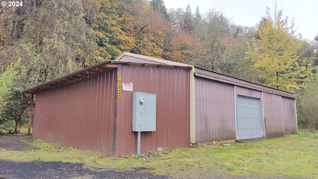 view of outbuilding with an outdoor structure and a forest view