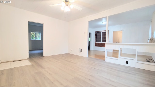 empty room with light hardwood / wood-style flooring and ceiling fan