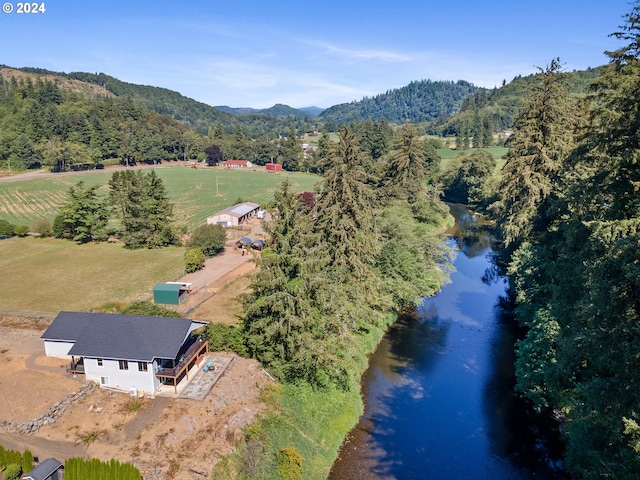 aerial view with a water and mountain view and a rural view