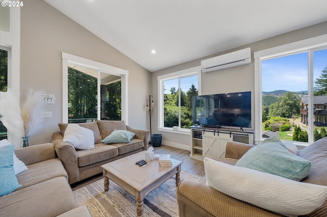 living room featuring lofted ceiling, a wall mounted air conditioner, plenty of natural light, and light hardwood / wood-style floors