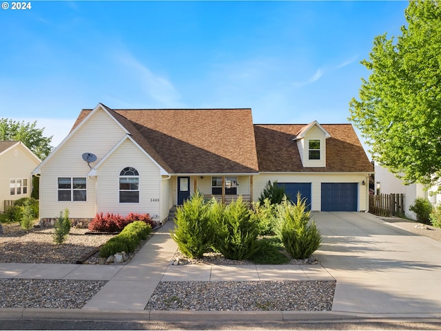 view of front facade featuring a garage, concrete driveway, and a shingled roof