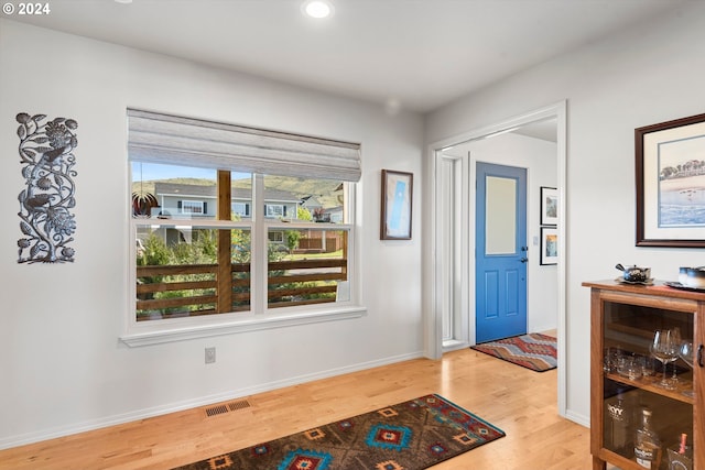 entryway with recessed lighting, wood finished floors, visible vents, and baseboards