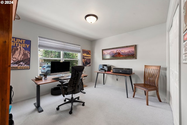 office with light carpet and baseboards