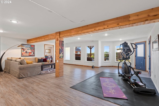 workout area featuring light wood-style flooring, baseboards, and recessed lighting