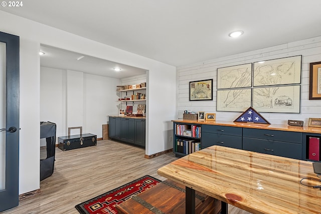 office with wooden walls, recessed lighting, light wood-type flooring, and baseboards