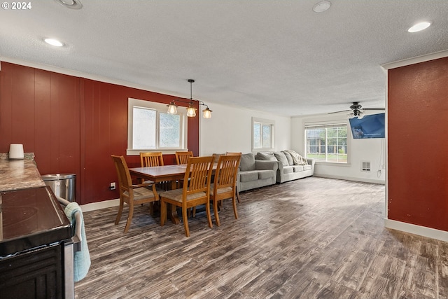 dining room with a textured ceiling, ceiling fan, and dark wood-type flooring