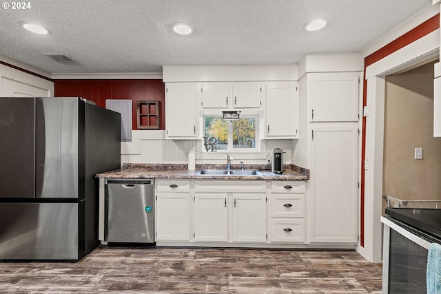 kitchen featuring white cabinetry, sink, dark wood-type flooring, and appliances with stainless steel finishes