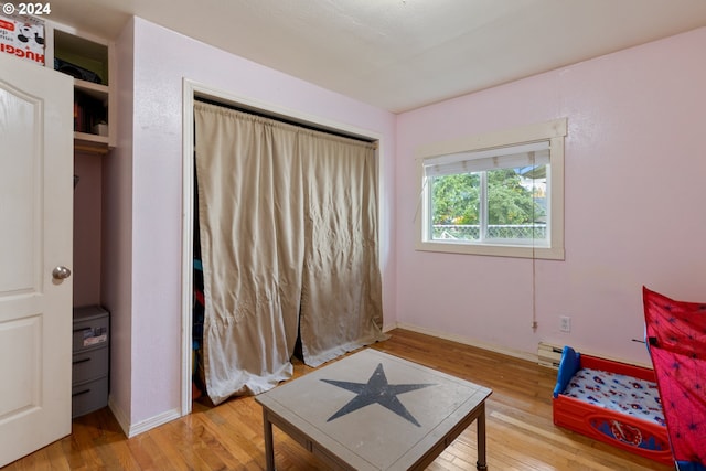 sitting room featuring wood-type flooring and baseboard heating