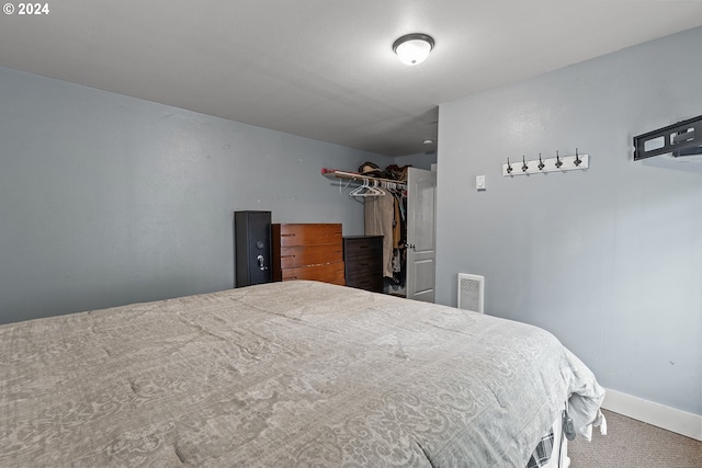 bedroom with carpet flooring and a closet